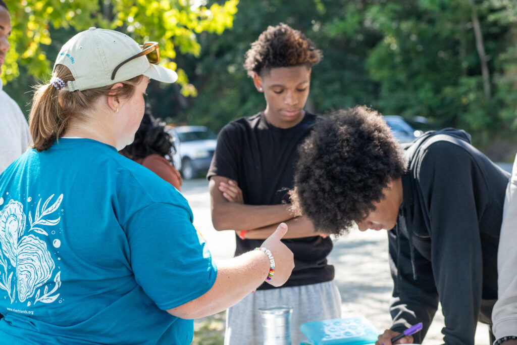Students work learn about water quality from Friends of the Rappahannock Educator